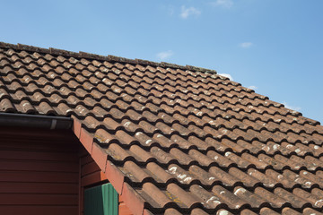 Detail of roof tiles from a garden house on a sunny day with blue sky backgrounds