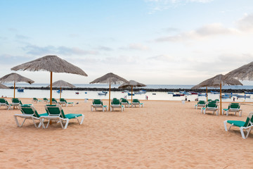 Fototapeta na wymiar Beach with chairs and umbrellas