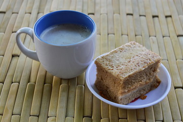 cake and milk coffee on bamboo plate