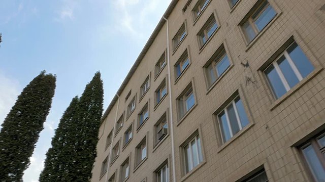 Office or factory block building exterior pan and tilt shot. 4K UHD video footage.