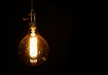 Edison light bulb on black background