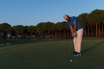 golfer  hitting shot at golf course