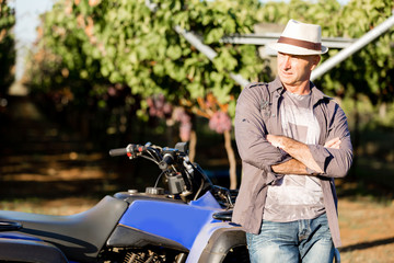 Man standing next to truck in vineyard