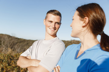 Obraz premium Young couple on beach training together