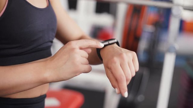 Smart watch showing a heart rate of exercising woman in gym