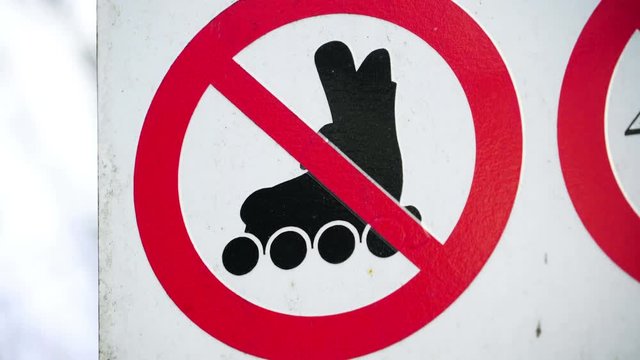 No rollerskates sign on the street means no one is allowed to cross the street using a rollerskates or blades