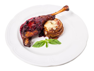 Delicious duck leg confit with red sauce.