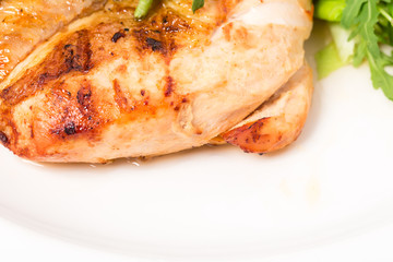 Grilled chicken fillet with fresh basil leaves.