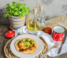 Tasty pizza with vegetables and basil on wooden table