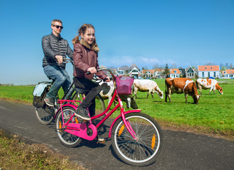 Father and daughter cycling through countryside - 108543847