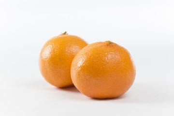 Closeup on Orange Clementines in Bright Studio