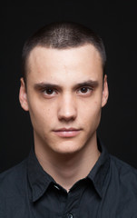 Serious young adult boy portrait.