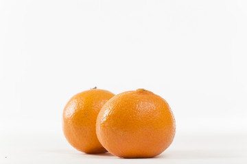 Closeup on Orange Clementines in Bright Studio
