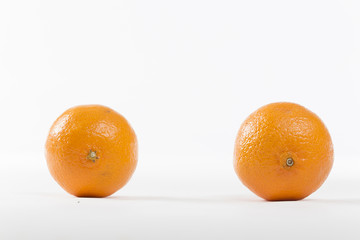 Closeup on Orange Clementines in Bright Studio