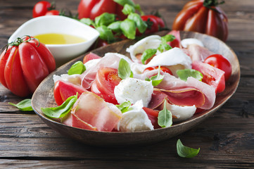 Italian salad caprese with prosciutto