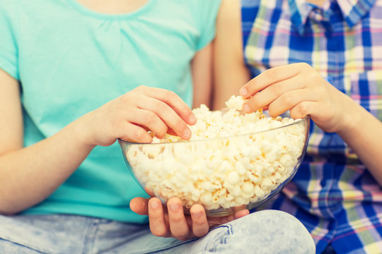 Close Up Of Kids With Popcorn Bowl Eating