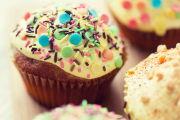 close up of glazed cupcakes or muffins on table