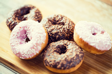 close up of glazed donuts pile on table