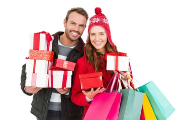 Happy young couple holding gifts and shopping bags