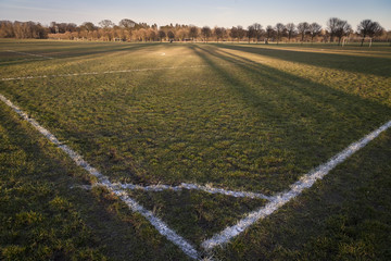 Wide angle panoramic view of a football pitch at dusk  © occupied_spaces