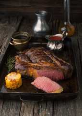 Sliced medium rare grilled Black Angus Steak Ribeye with rosemar