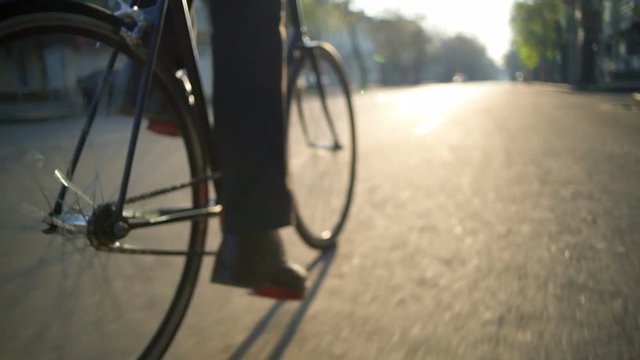 man riding a bicycle on the empty road slow motion