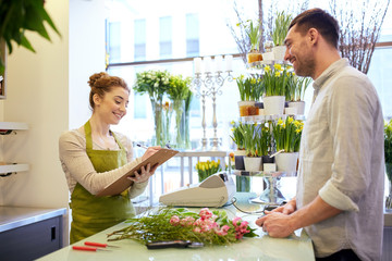 florist woman and man making order at flower shop