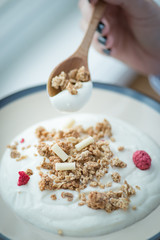 A cup of fresh yogurt in woman's hands