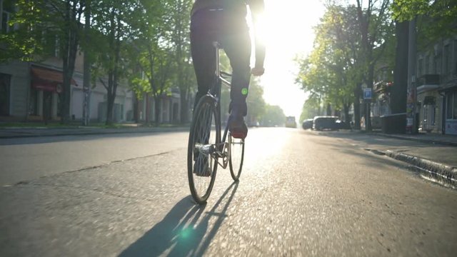 man riding a bicycle on the empty road slow motion