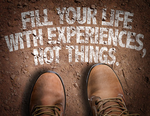 Top View of Boot on the trail with the text: Fill Your Life With Experiences, Not Things