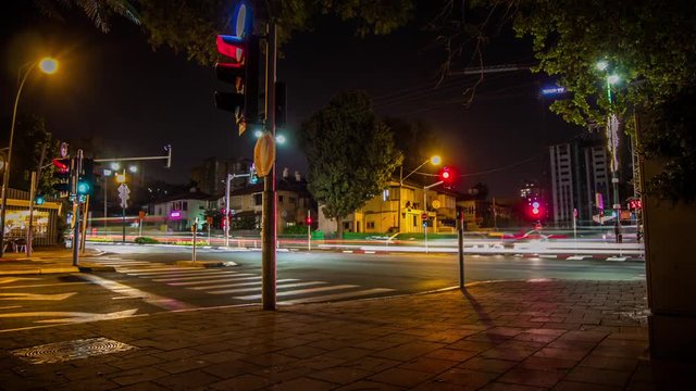 A night time lapse of cars waiting the traffic light