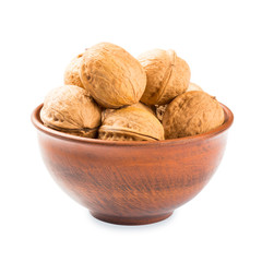 Walnuts in a clay bowl - isolated on white background