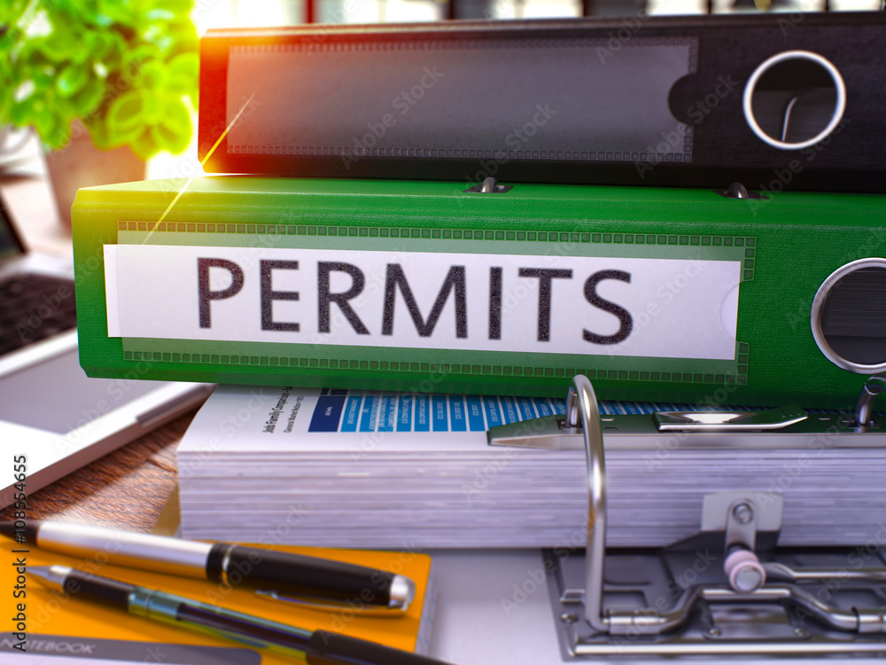 Poster permits - green office folder on background of working table with stationery and laptop. permits bus