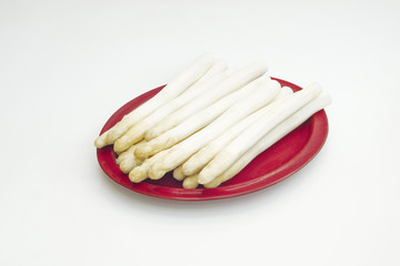 Group of white asparagus placed on a plate with isolated background