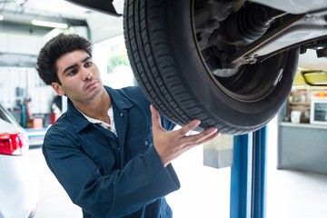 Mechanic fixing a car wheel
