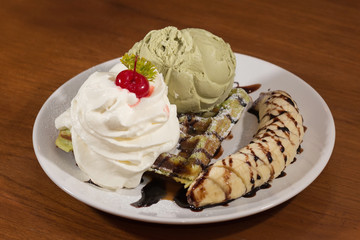 Waffle green tea icecream with chocolate topping on banana fruit