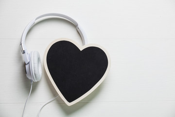 White headphones with heart on white background