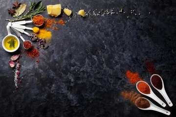 Fotobehang Herbs and spices over black stone © karandaev