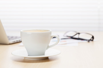 Office workplace with with laptop and coffee