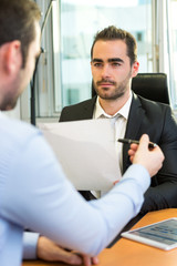 Fototapeta premium Attractive boss doing interview with his assistant