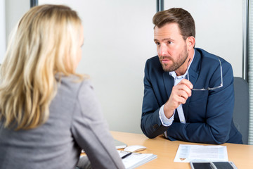Young attractive employer doing a job interview to a woman