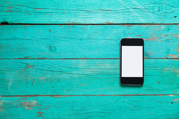 Smart phone on color wooden table background with copy space