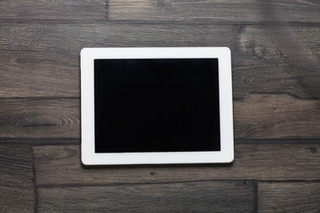White Tablet. Tablet pc on wooden table