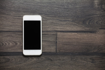 Smart phone on wooden table background with copy space
