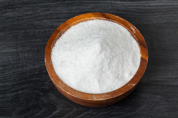 Fototapeta na wymiar salt in bowl on the wooden table in kitchen