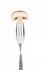 Cut half button mushroom on fork, isolated on white background.