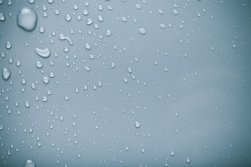 Dops of water on a color background. Gray. Toned