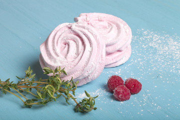 Fresh pink homemade zephyr - marshmallow on blue wooden table