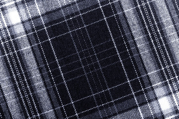 Textured surface of checkered cloth. Toned