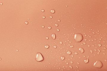 Drops of water on a color background. Brown. Shallow depth of fi
